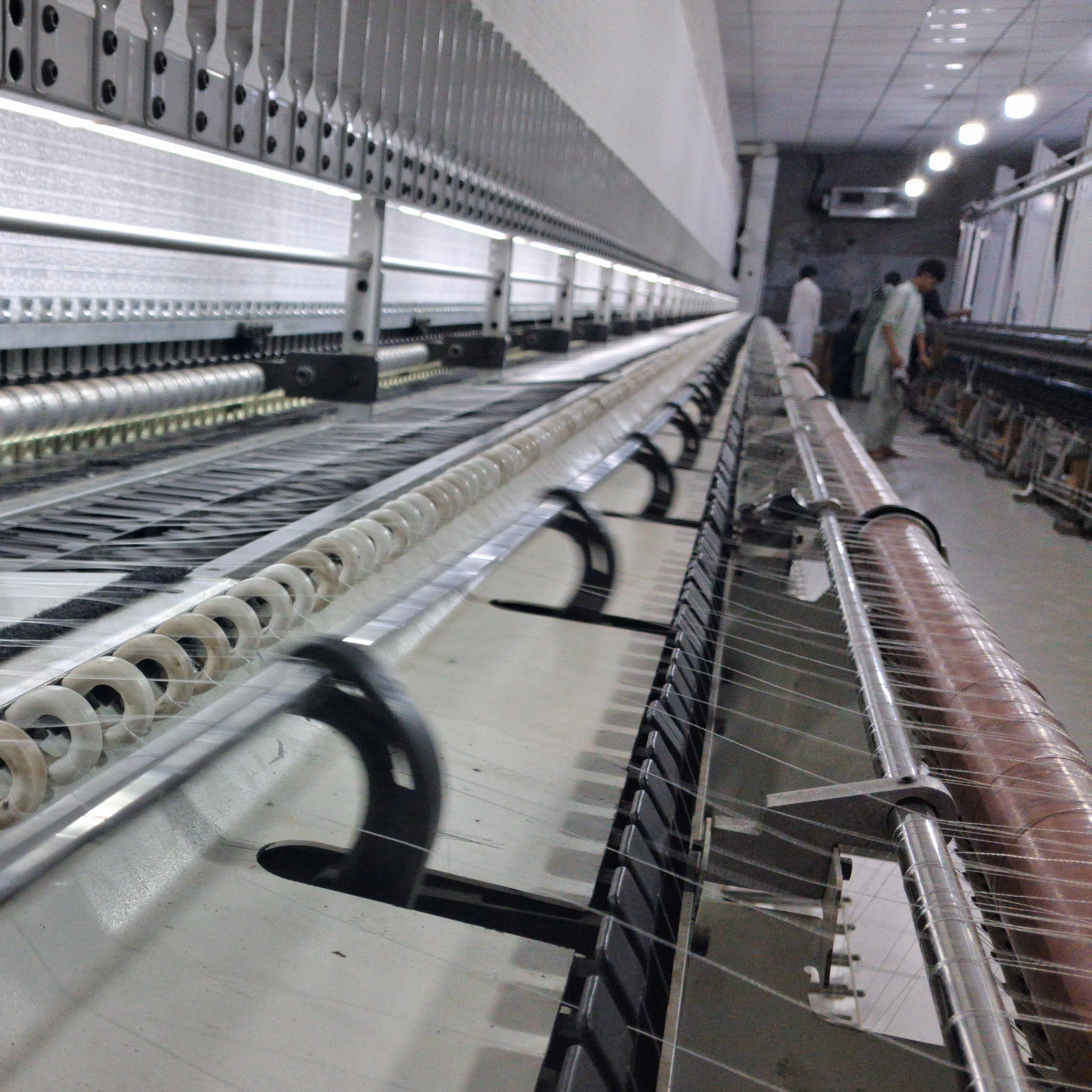 Close-up of embroidery machine needles in motion