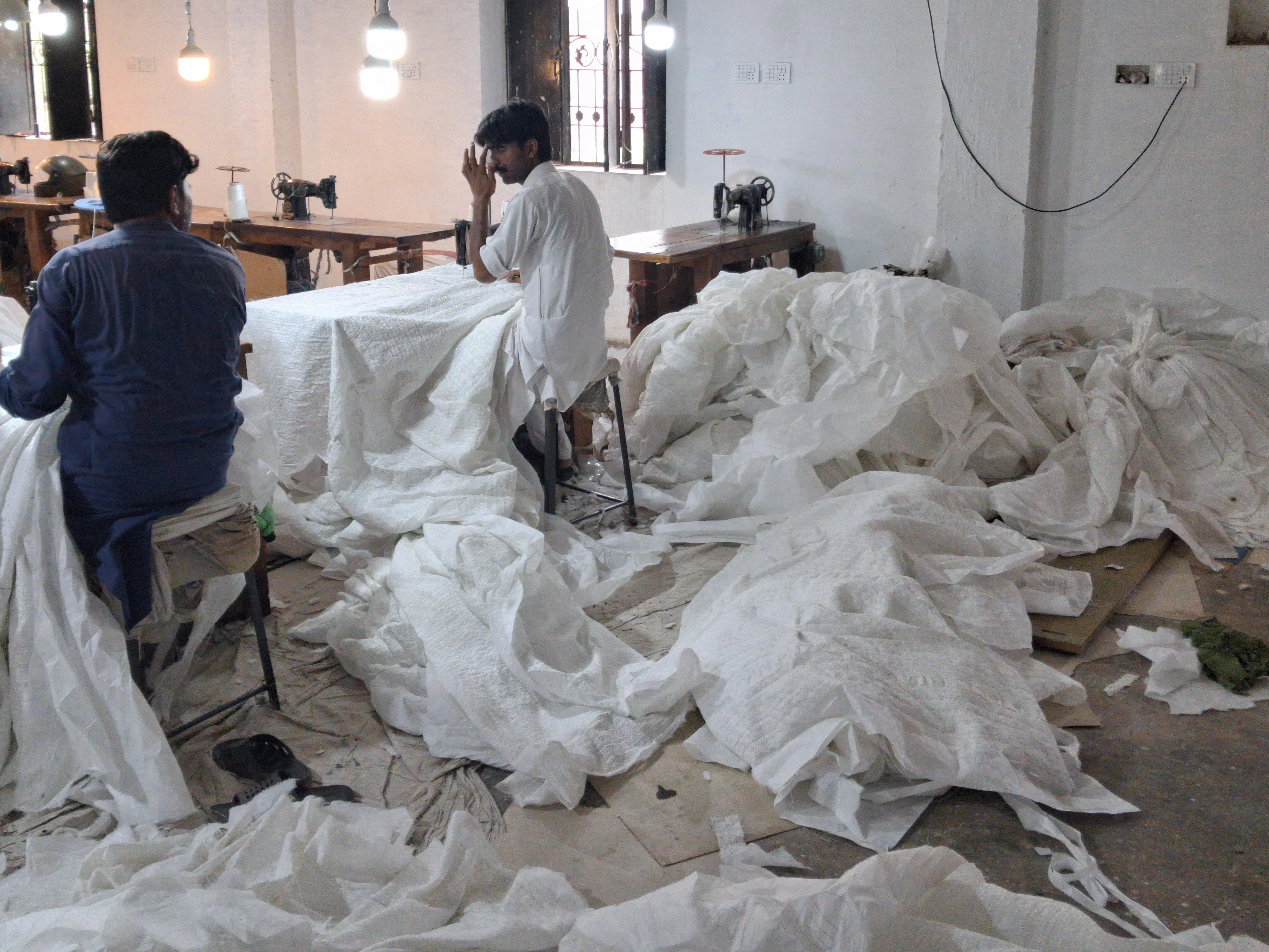 TNE quality control team inspecting finished embroidered fabric